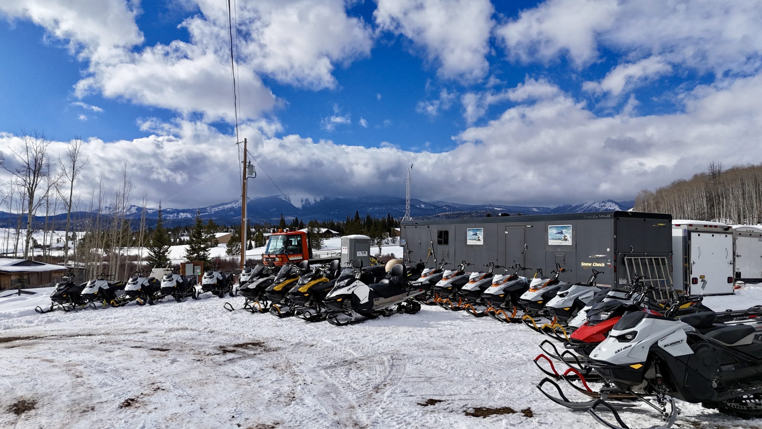 Rocky Mountain Sled Rentals fleet lined up at basecamp in Clark, Colorado